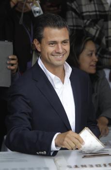 Kandidát centristickej Inštitucionálnej revolučnej strany (PRI) Enrique Pena Nieto vhadzuje hlasovací lístok do urny v najväčších voľbách v dejinách krajiny 1. júla 2012 v Atlacomulce.